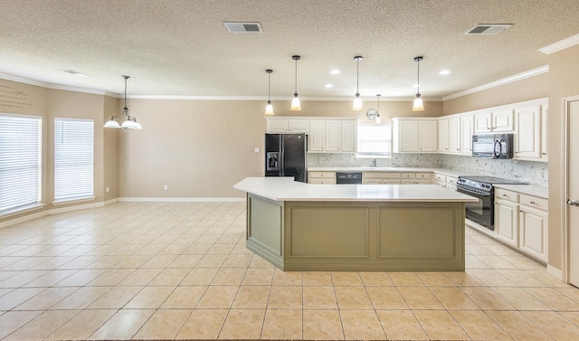 kitchen featuring tasteful backsplash, white cabinetry, black appliances, and a center island