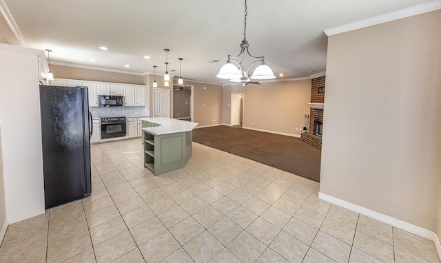 kitchen featuring black appliances, a brick fireplace, a kitchen island, pendant lighting, and white cabinets