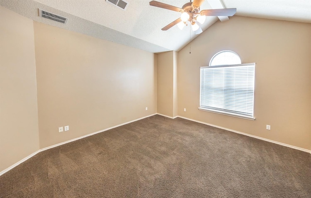 carpeted empty room featuring lofted ceiling, a textured ceiling, and ceiling fan