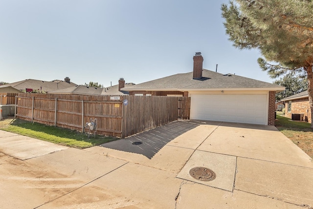 view of side of property with cooling unit and a garage