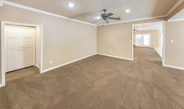 carpeted empty room with ceiling fan, ornamental molding, and a textured ceiling