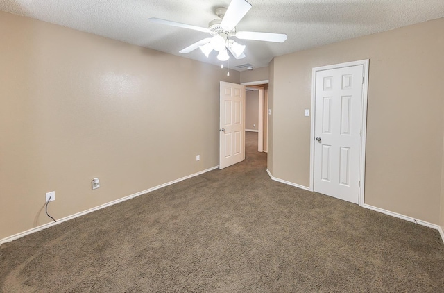 carpeted empty room with ceiling fan and a textured ceiling