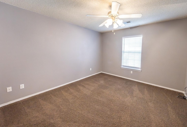 unfurnished room with ceiling fan, carpet flooring, and a textured ceiling