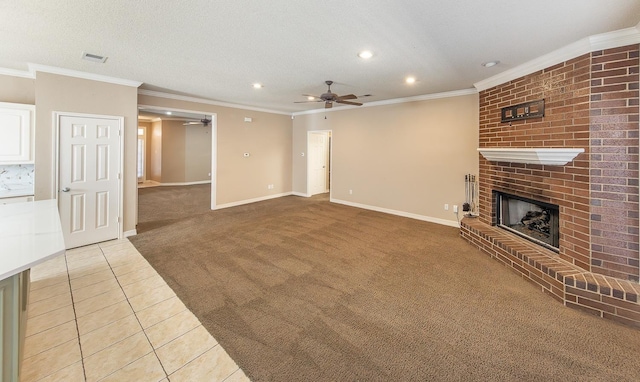 unfurnished living room featuring crown molding, a fireplace, ceiling fan, and light tile patterned flooring