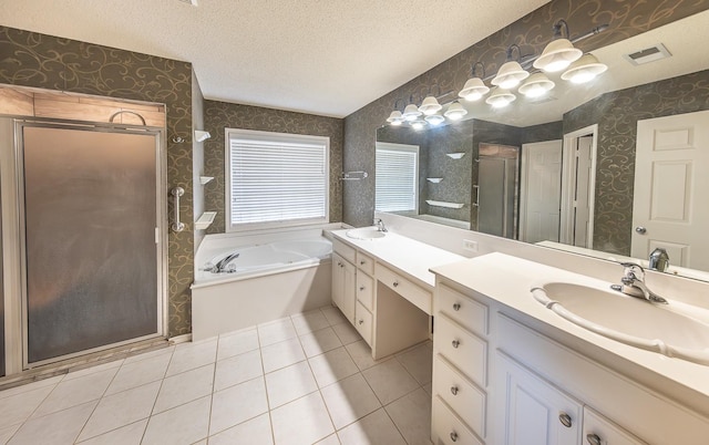 bathroom featuring vanity, tile patterned floors, a textured ceiling, and separate shower and tub