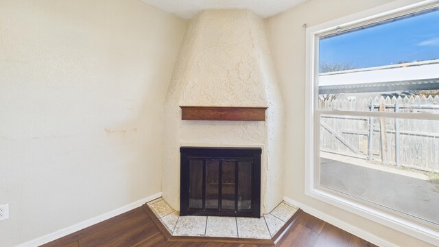 5768 38th St, Lubbock, TX 79407 - room details featuring a fireplace, baseboards, and wood finished floors