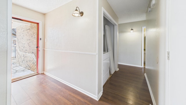 5768 38th St, Lubbock, TX 79407 - hall featuring a textured ceiling, wood finished floors, and baseboards