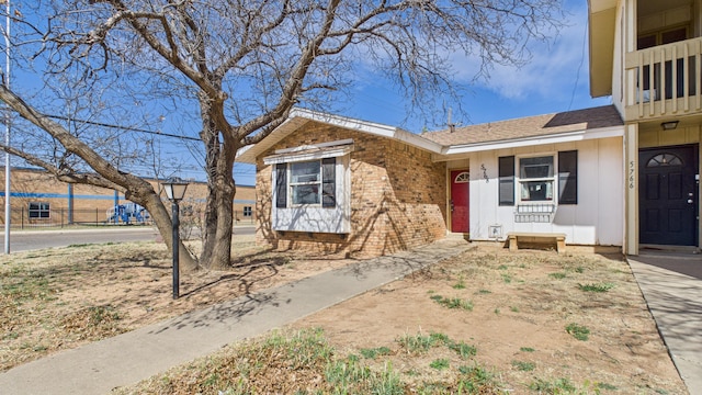 view of front of home with brick siding and board and batten siding