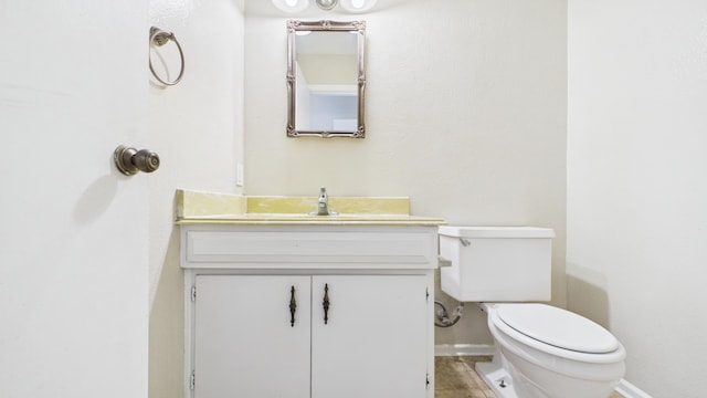5768 38th St, Lubbock, TX 79407 - bathroom with baseboards, vanity, and toilet
