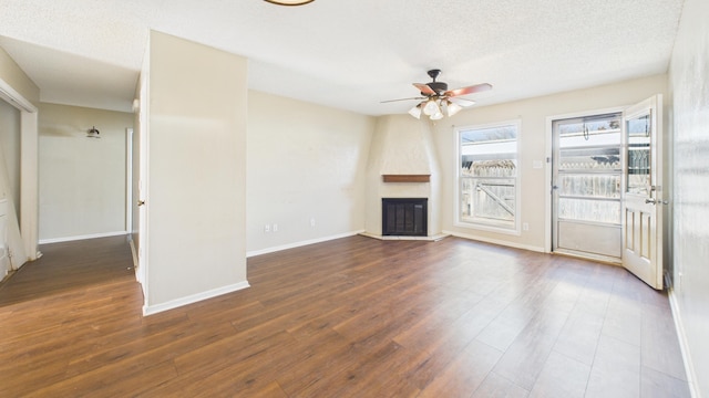 5768 38th St, Lubbock, TX 79407 - unfurnished living room with a fireplace, ceiling fan, a textured ceiling, wood finished floors, and baseboards