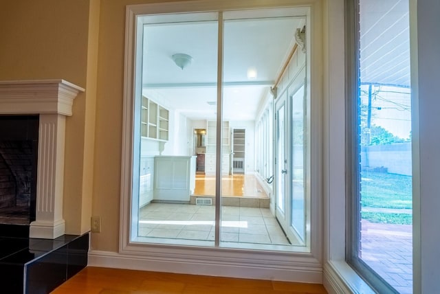 doorway with wood-type flooring and plenty of natural light