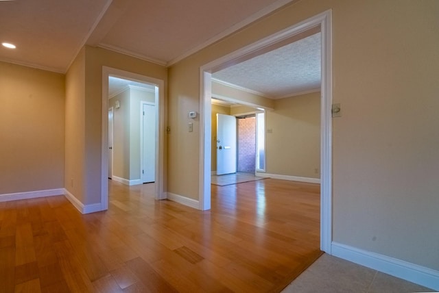 spare room with light hardwood / wood-style flooring and ornamental molding