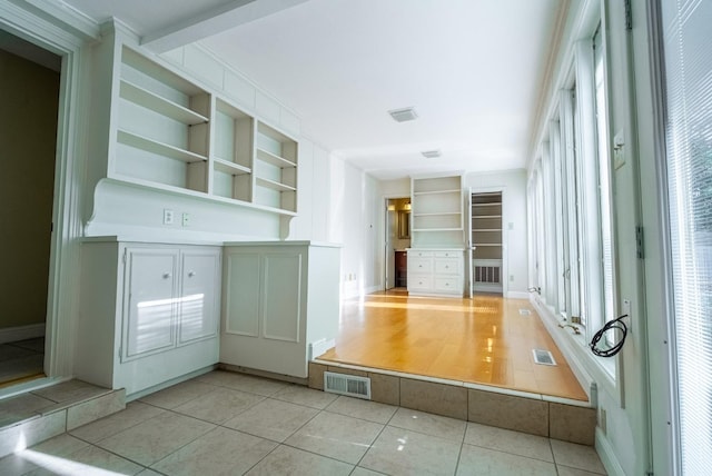 interior space with built in features and light tile patterned floors