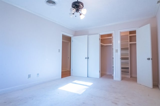 unfurnished bedroom featuring crown molding and light colored carpet