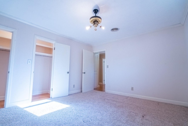 unfurnished bedroom with ornamental molding and carpet flooring