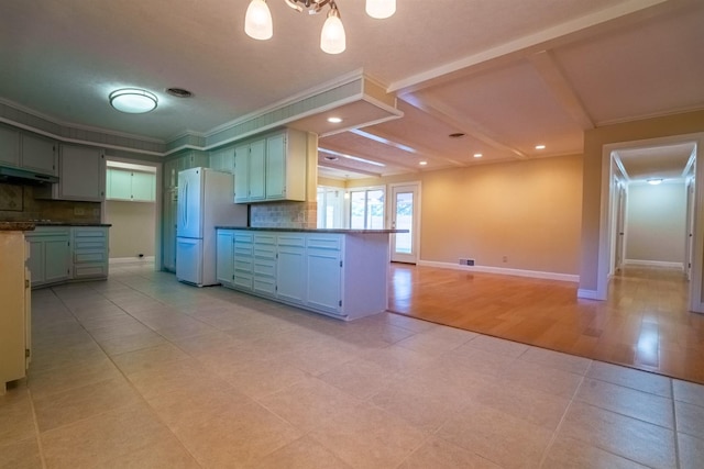 kitchen with light tile patterned flooring, tasteful backsplash, white fridge, green cabinetry, and crown molding