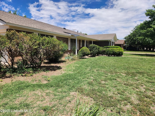5520 36th St, Lubbock, TX 79407 - view of front facade featuring a front lawn and brick siding