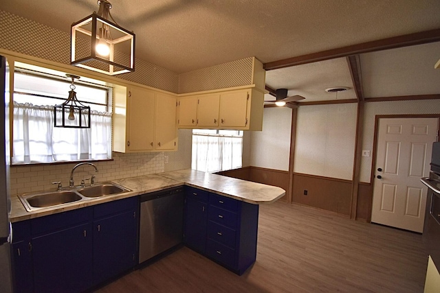 kitchen featuring pendant lighting, dishwasher, sink, white cabinets, and kitchen peninsula