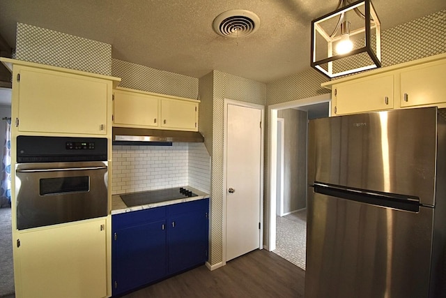 kitchen featuring decorative light fixtures, tasteful backsplash, dark hardwood / wood-style flooring, stainless steel appliances, and a textured ceiling