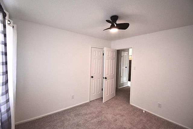 unfurnished bedroom with ceiling fan and carpet flooring