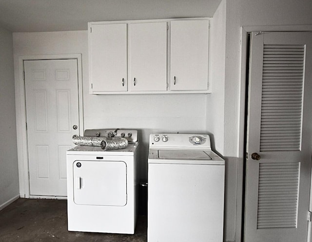 laundry area featuring cabinets and washer and clothes dryer