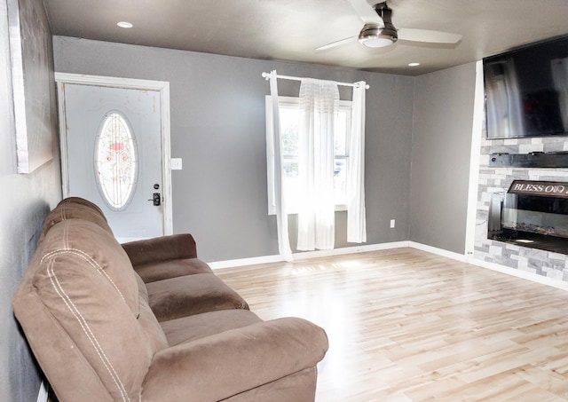 living room featuring ceiling fan and light hardwood / wood-style floors