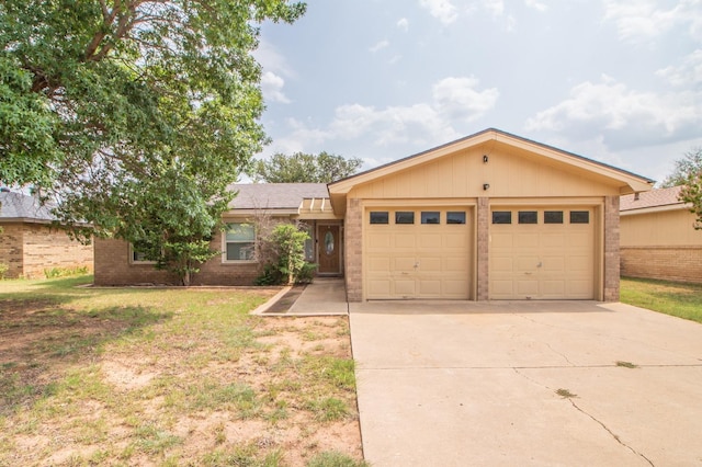 ranch-style home with a garage and a front yard