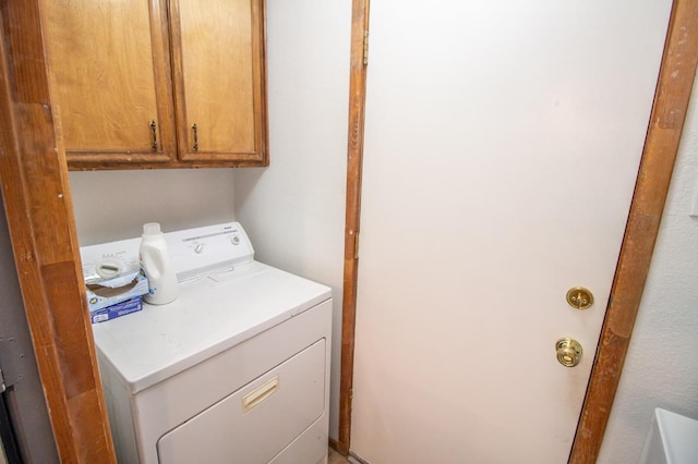 laundry room with cabinets and washer / clothes dryer