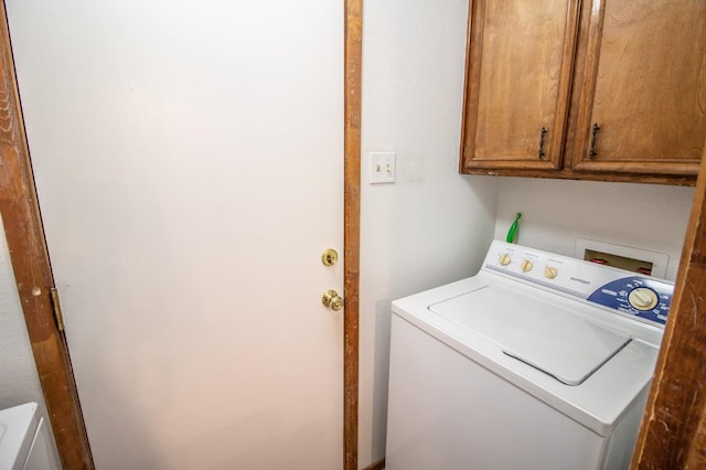 laundry area with washer / dryer and cabinets