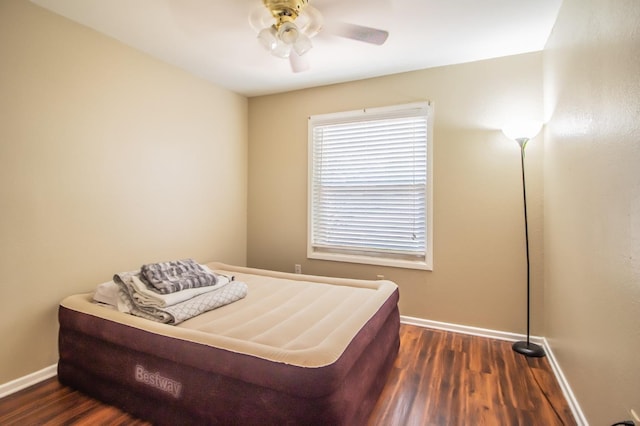 bedroom with ceiling fan and dark hardwood / wood-style flooring