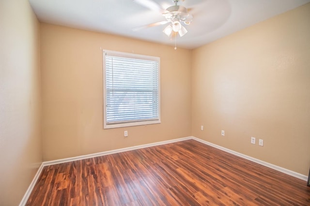 unfurnished room with dark wood-type flooring and ceiling fan