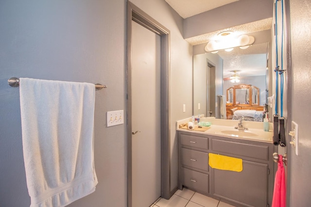 bathroom featuring tile patterned floors, vanity, and a textured ceiling