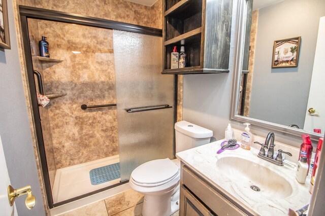 bathroom with vanity, an enclosed shower, and toilet