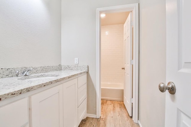 bathroom with vanity and hardwood / wood-style floors