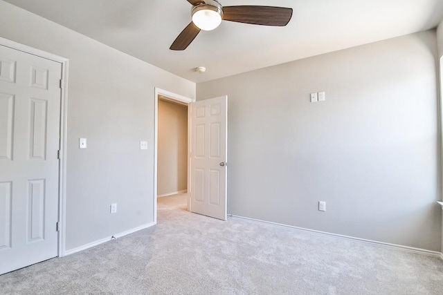 unfurnished bedroom with ceiling fan and light carpet