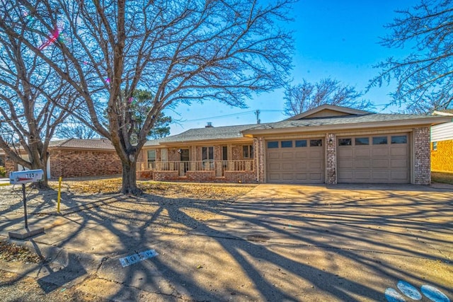 ranch-style home featuring a garage and a porch