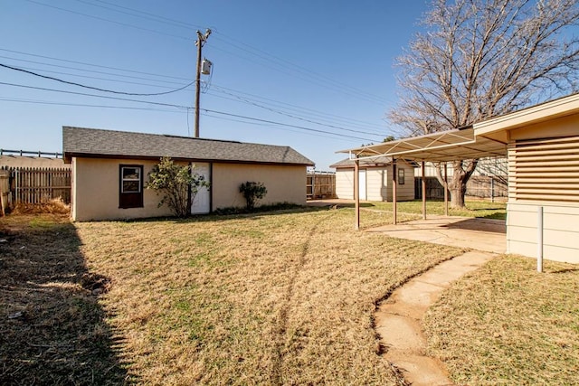 view of yard with an outdoor structure and a patio