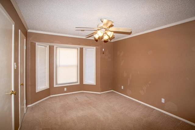 unfurnished room with ceiling fan, light colored carpet, ornamental molding, and a textured ceiling