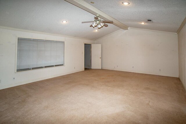 spare room featuring crown molding, ceiling fan, vaulted ceiling with beams, carpet, and a textured ceiling