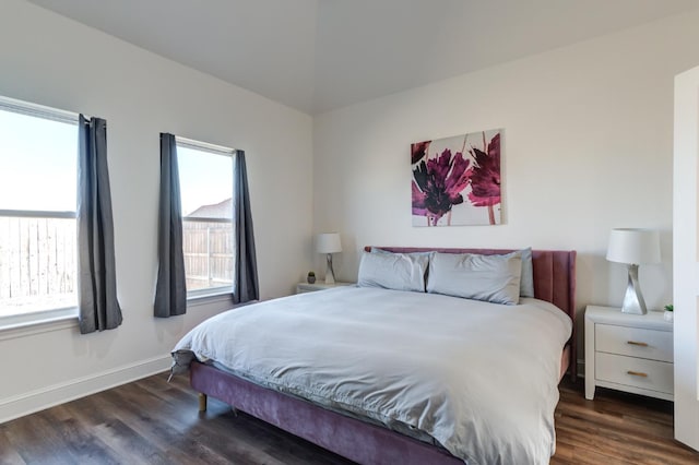 bedroom with dark wood-style floors and baseboards