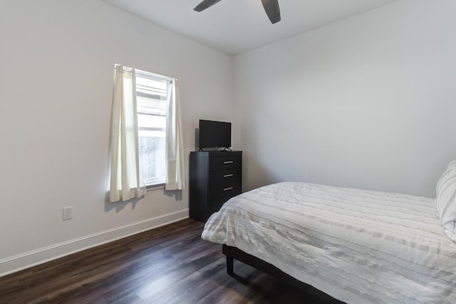 bedroom featuring a ceiling fan, dark wood-style floors, and baseboards