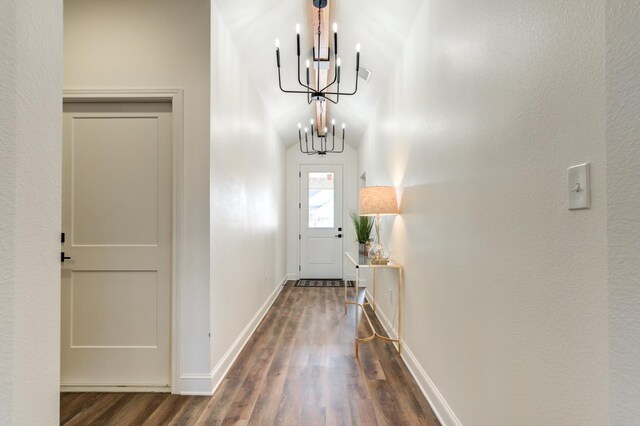 entryway with baseboards, visible vents, wood finished floors, and a notable chandelier