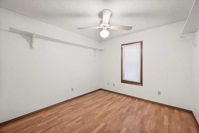 empty room featuring ceiling fan, a textured ceiling, and light hardwood / wood-style flooring