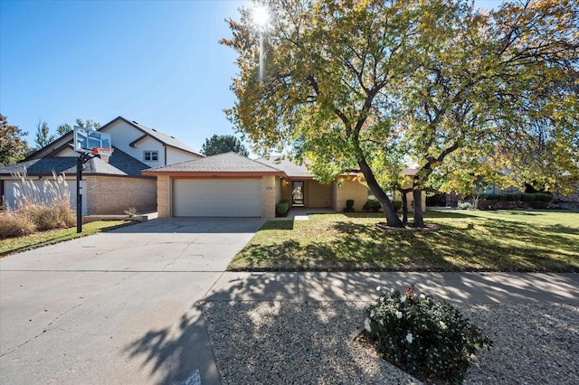 view of front of house featuring a garage and a front lawn