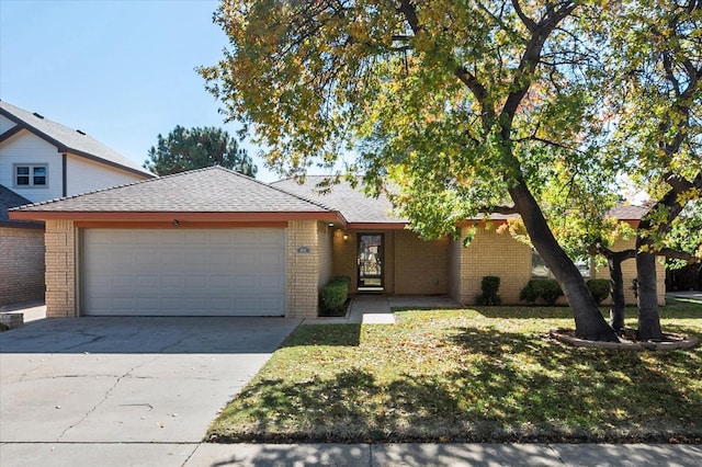 view of front of home with a garage and a front yard