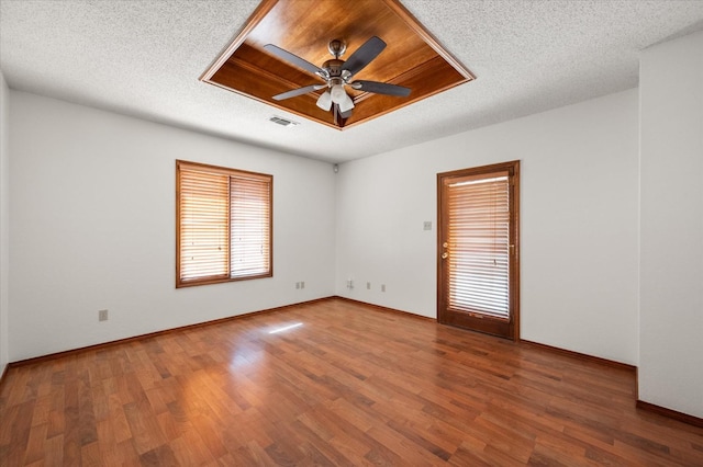 unfurnished room with ceiling fan, hardwood / wood-style floors, and a textured ceiling