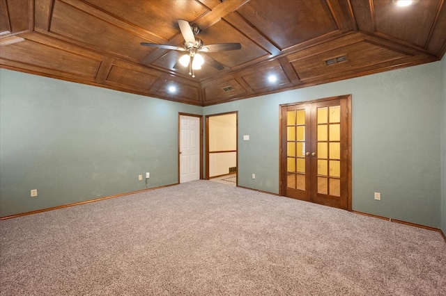 carpeted spare room featuring french doors, coffered ceiling, wooden ceiling, ornamental molding, and ceiling fan