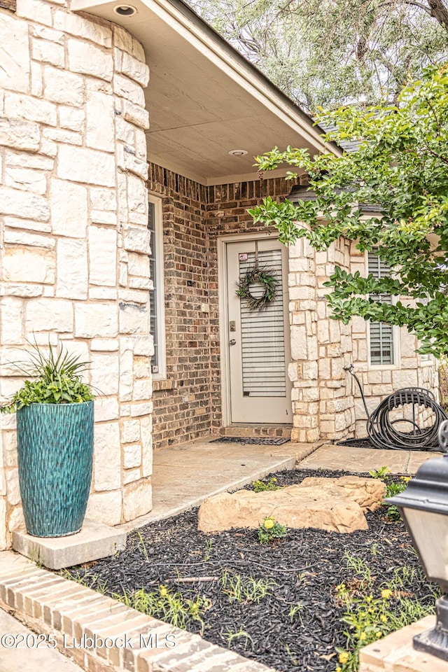 1510 Lancelot Ave, Wolfforth, TX 79382 - view of exterior entry with stone siding and brick siding