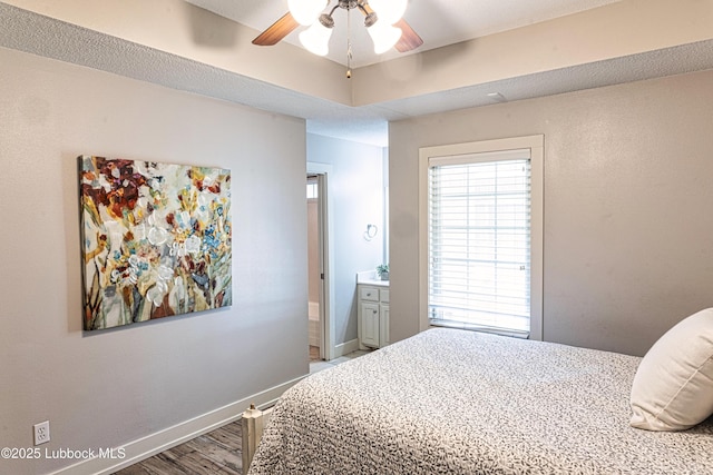 1510 Lancelot Ave, Wolfforth, TX 79382 - bedroom featuring wood finished floors, baseboards, ceiling fan, and connected bathroom