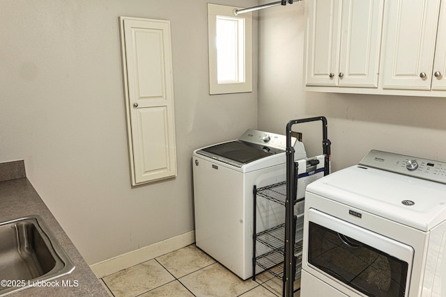 1510 Lancelot Ave, Wolfforth, TX 79382 - laundry room featuring cabinet space, washer and clothes dryer, light tile patterned flooring, and baseboards